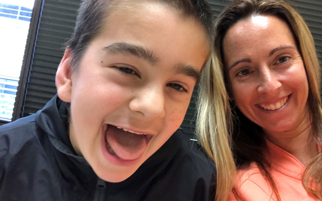 A mother and her young son posing for a goofy selfie