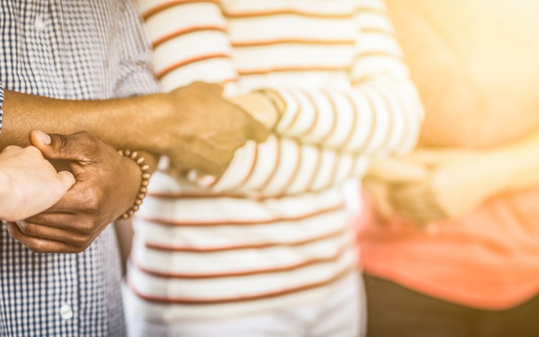 Group holding hands in community