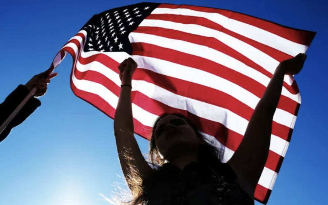 Person holding American flag in the wind