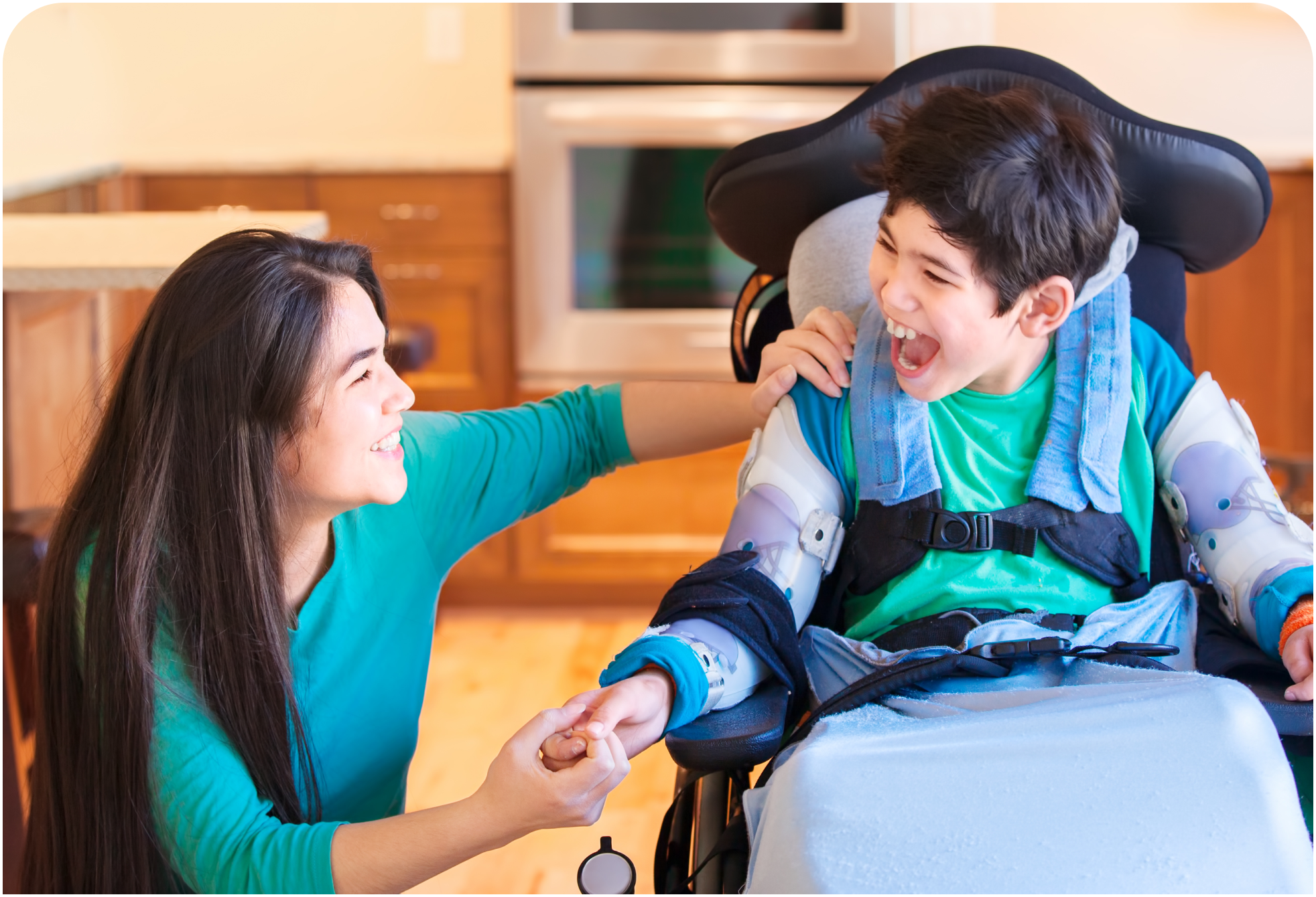 A handicapped child holding hands and smiling with his mother