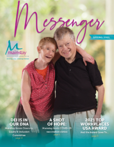 A male and female give a friendly side hug as they pose for the cover of the Spring 2021 Newsletter