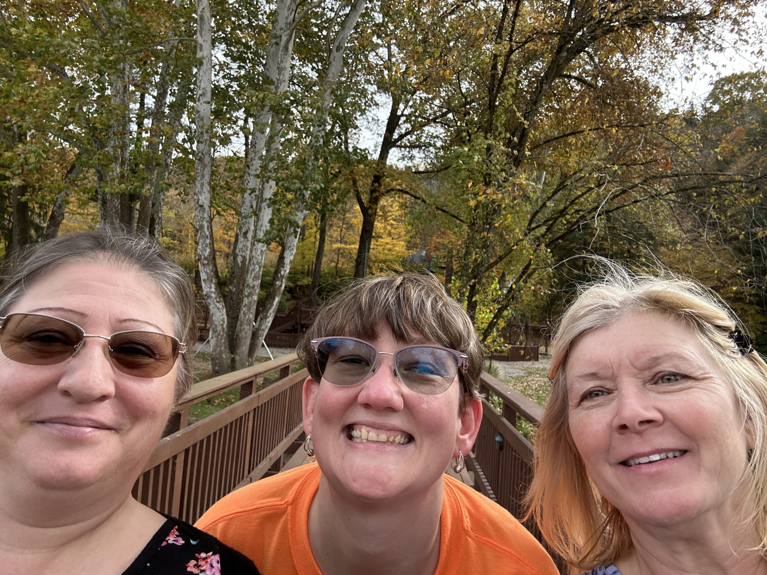 Renee, Helene, and another woman outside smiling for a selfie